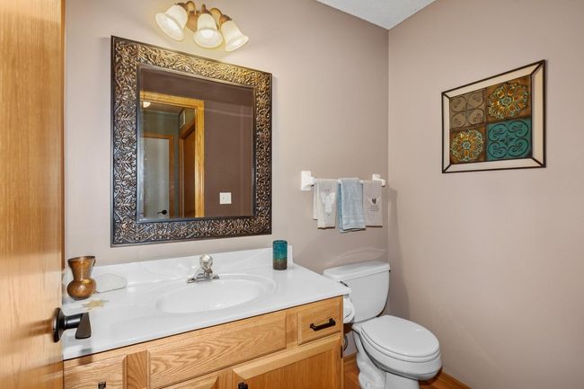 Main floor bath has vanity with storage space | Image 14