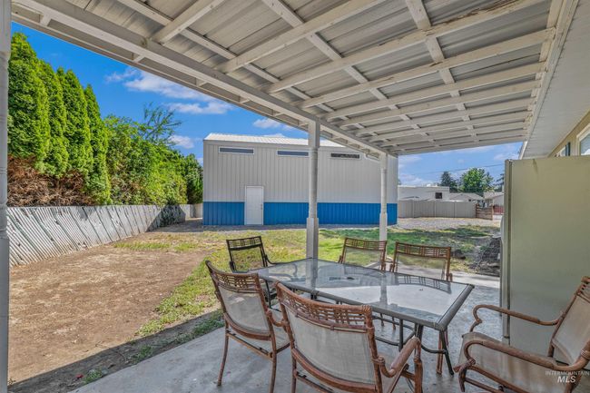 Fenced backyard with outdoor dining space and a patio area | Image 24
