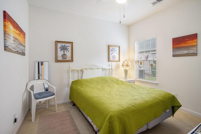 Bedroom featuring light carpet and ceiling fan | Image 16