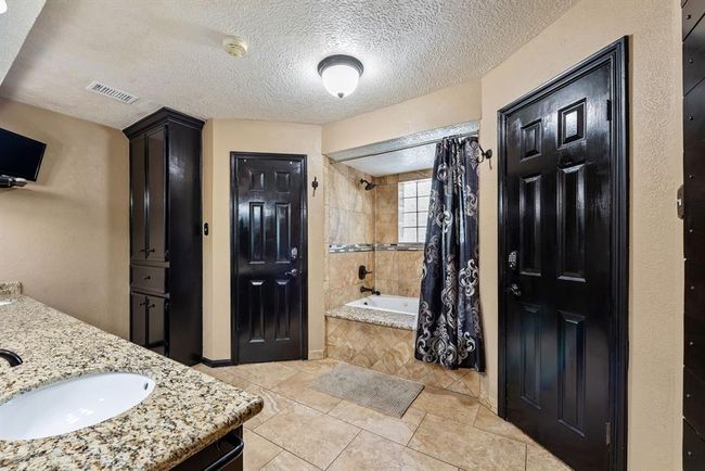En suite primary bath boasts his and her double closets. | Image 20