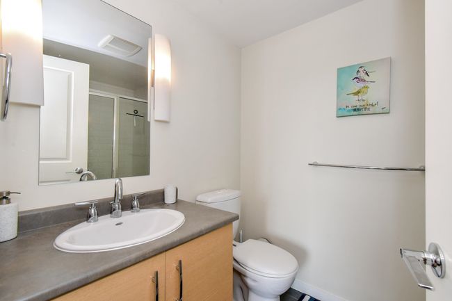 Bathroom featuring vanity and a shower with shower door | Image 11