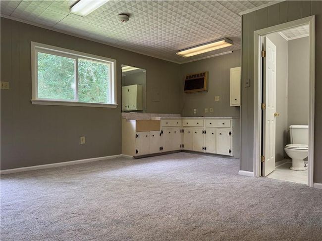 Bathroom featuring an AC wall unit and ornamental molding | Image 14