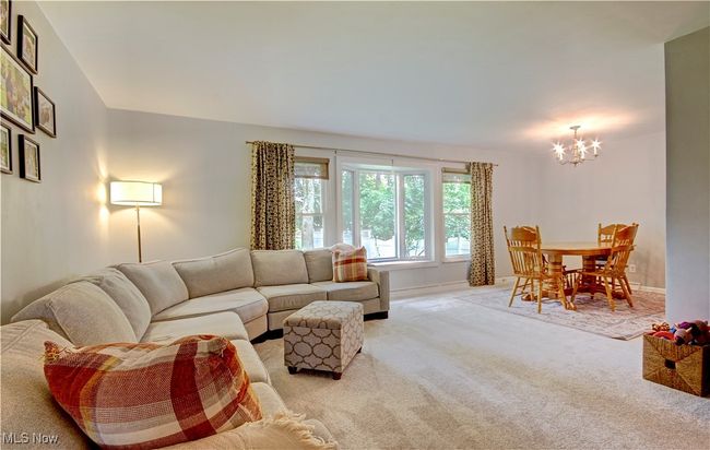 Living room featuring a chandelier and light colored carpet | Image 7