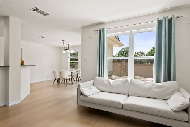 Living room views including kitchen, dining and backyard | Image 10
