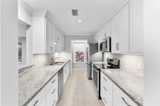 This gorgeous kitchen features all new cabinetry, countertops, fixtures & stainless steel appliances. | Image 9
