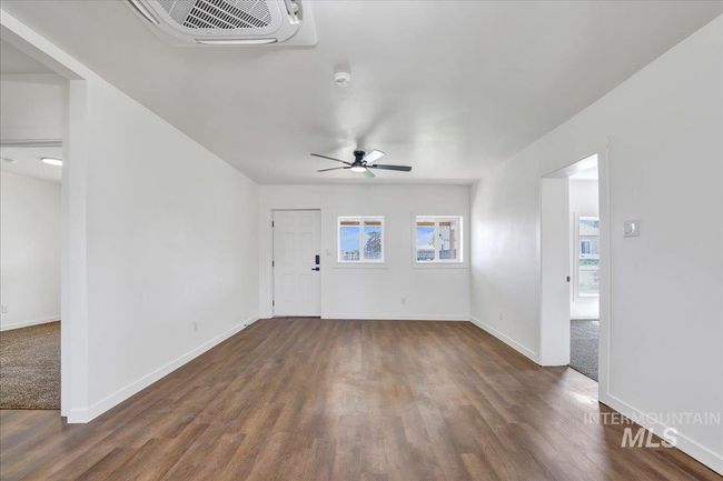 Empty room with wood finished floors and ceiling fan | Image 11