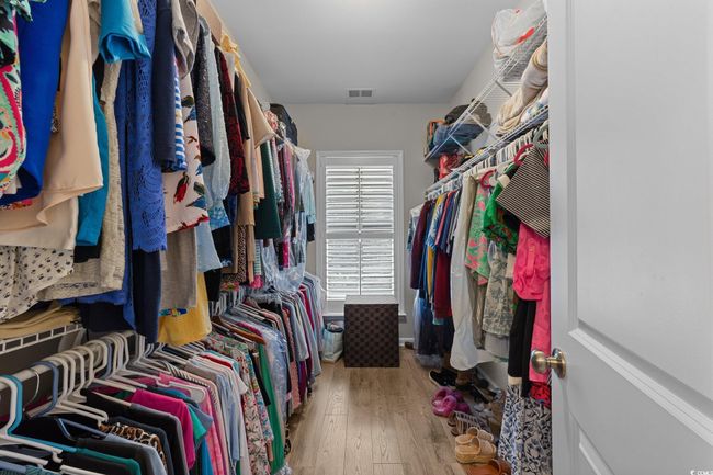 Walk in closet featuring hardwood / wood-style floors | Image 19