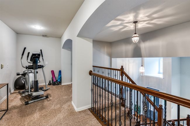 Loft area being used as and exercise room currently. Would make a great study area or flex space! | Image 25