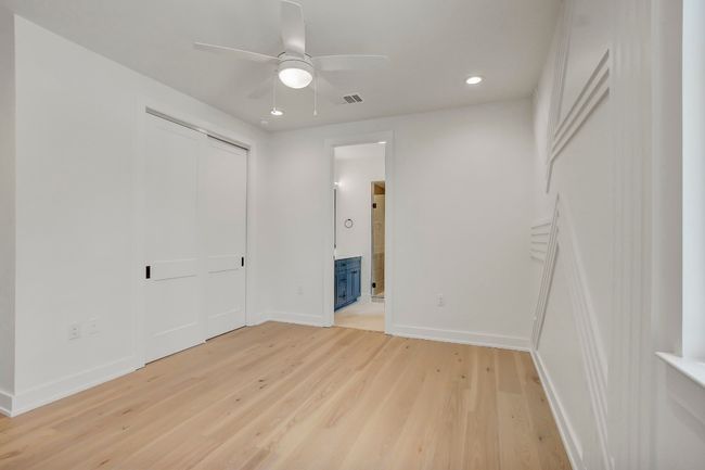Unfurnished bedroom featuring light wood finished floors, baseboards, recessed lighting, ensuite bathroom, and a closet | Image 19