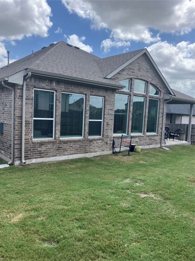 Back of property with brick siding, a patio, and roof with shingles | Image 29