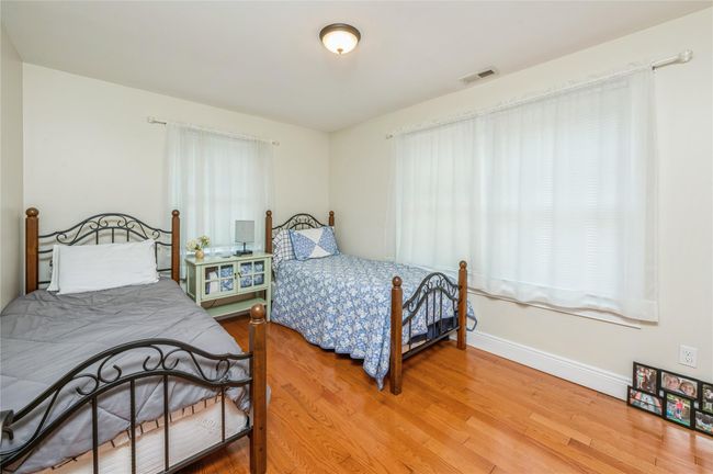 Bedroom featuring light wood-style floors and baseboards | Image 10