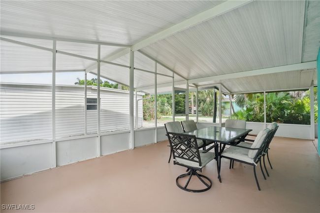 Sunroom / solarium featuring outdoor dining space and vaulted ceiling | Image 10