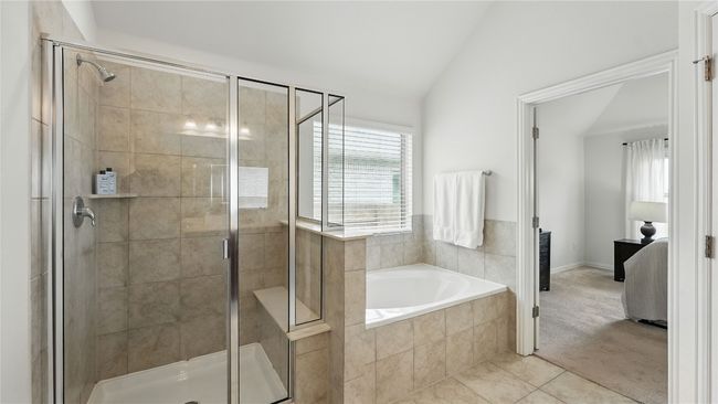 Ensuite bathroom with lofted ceiling, a bath, a stall shower, and tile patterned flooring | Image 27