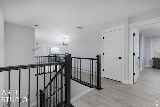 Hallway with an upstairs landing, light wood-style floors, and baseboards | Image 22