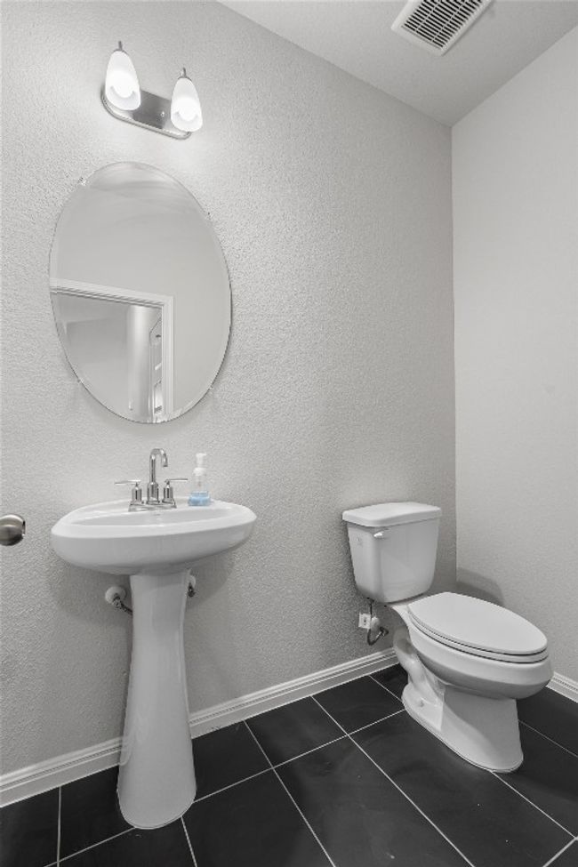 Bathroom featuring toilet and tile patterned floors | Image 19