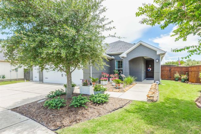 The front of the house features an inviting entrance, with a thoughtfully designed pathway guiding you to the welcoming door. The architectural details enhance its curb appeal, offering an elegant first impression. | Image 37