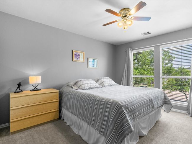 Carpeted bedroom with ceiling fan | Image 29