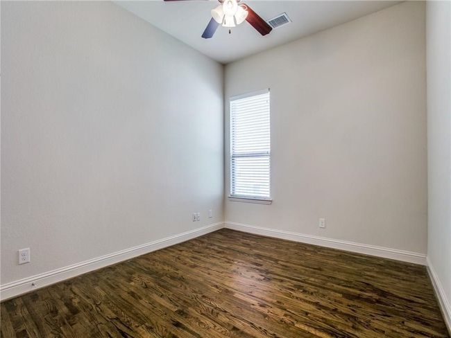 Spare room featuring dark wood-style floors, baseboards, and ceiling fan | Image 16