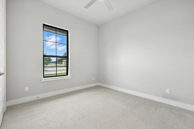 Carpeted empty room with ceiling fan and baseboards | Image 22