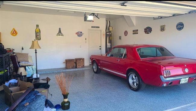 Garage with water heater and a garage door opener | Image 27