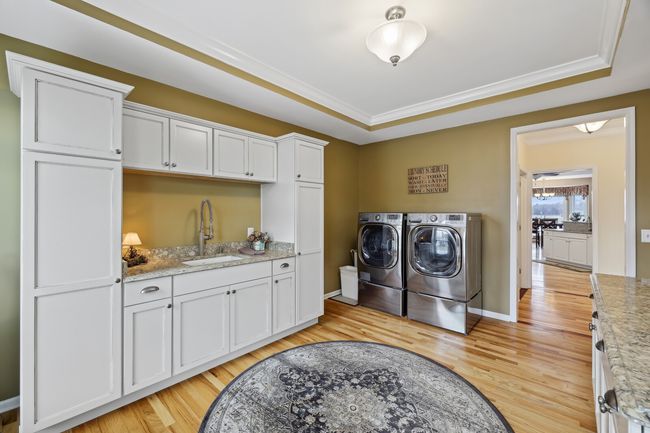 Previous owners converted the former dining room into a wonderfully functional laundry/multipurpose room. Current owners renovated with new cabinets, counters and a cast iron sink. | Image 18