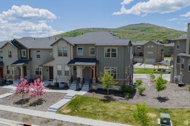 View of front facade with board and batten siding, a residential view, a mountain view, and stone siding | Image 42