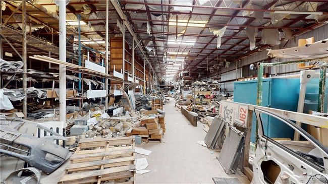 Misc room featuring concrete floors and a workshop area | Image 32