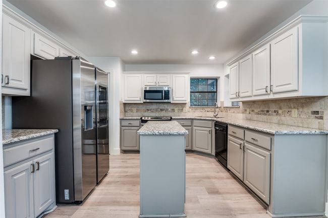 Kitchen featuring stainless steel appliances, a center island, gray cabinetry, tasteful backsplash, and recessed lighting | Image 8