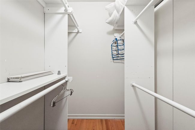 Spacious closet with light wood-style flooring | Image 25
