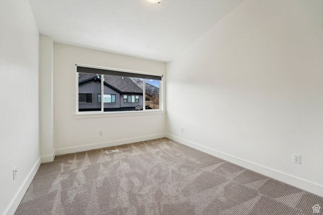 Spare room featuring carpet, visible vents, and baseboards | Image 39