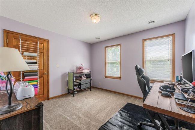 Office space featuring baseboards, a textured ceiling, visible vents, and light colored carpet | Image 53