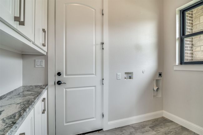Clothes washing area featuring light hardwood / wood-style floors, cabinets, electric dryer hookup, and washer hookup | Image 9