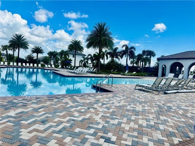 View of community pool with a patio area | Image 35