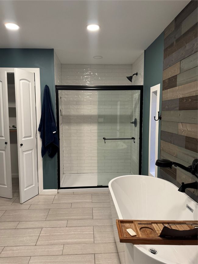 Full bathroom featuring a shower stall, wood tiled floors, recessed lighting, and a freestanding bath | Image 16