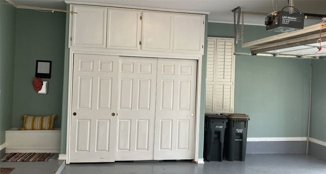 On the right wall, there is a storage closet with sliding doors and window. | Image 32