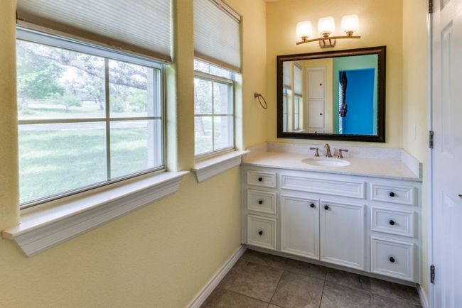 Bathroom with vanity, baseboards, and tile patterned flooring | Image 27