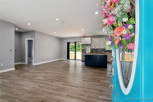 Unfurnished living room with wood finished floors, recessed lighting, and baseboards | Image 8