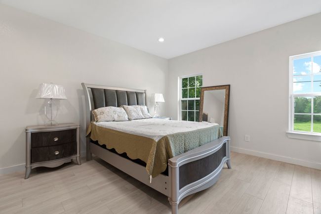 Bedroom with light wood-style flooring and recessed lighting | Image 22