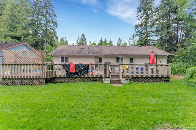 Back of property featuring a lawn and a wooden deck | Image 18