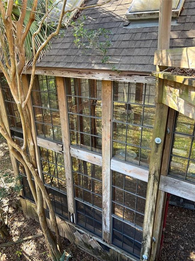 Rustic greenhouse with ample natural light and a cozy, inviting design. Ideal for garden enthusiasts. | Image 14