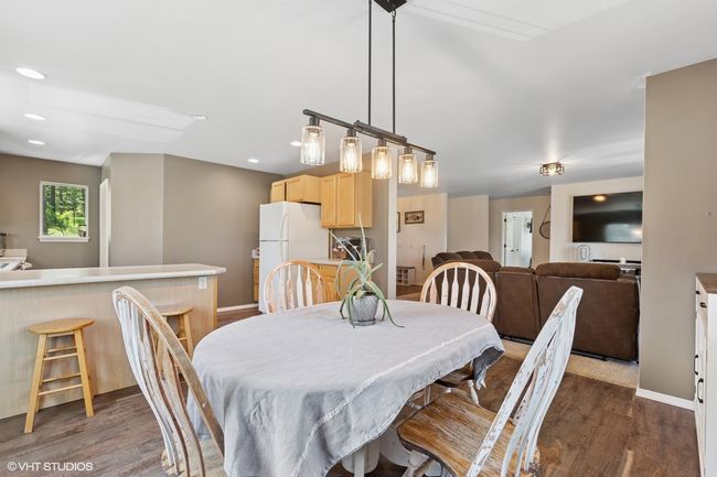 Dining space with dark wood-type flooring, baseboards, and recessed lighting | Image 8