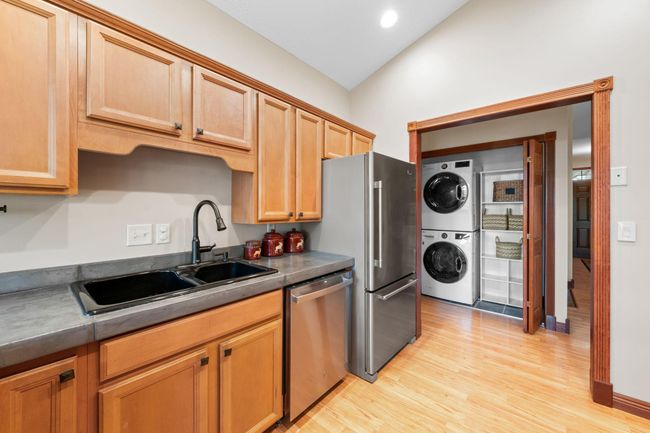 Main floor laundry closet is super convenient in the hallway with LG stackable washer/dryer. | Image 16