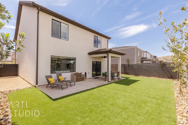 Rear view of property with a patio, a yard, stucco siding, and a fenced backyard | Image 39