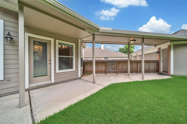A covered walkway connects the garage to back door so you'll never have to walk through the rain. | Image 29