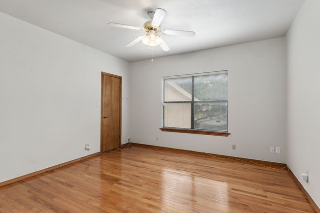 Spare room with ceiling fan and light wood-style flooring | Image 20