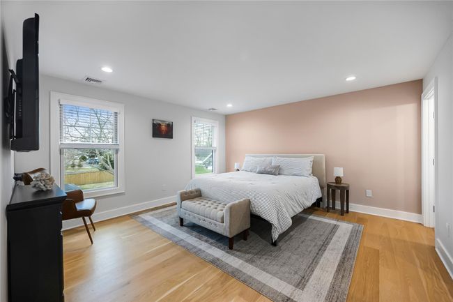 Bedroom featuring baseboards, visible vents, light wood-style flooring, and recessed lighting | Image 30