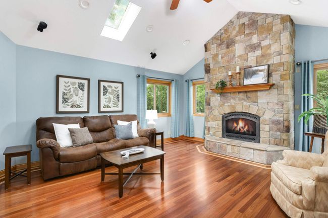 Cozy up to the floor to ceiling stone fireplace. | Image 14