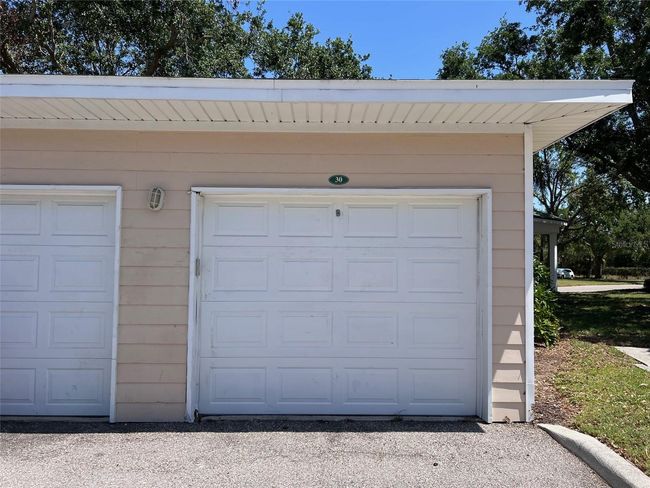 Detached one car garage is deeded to condo. | Image 25