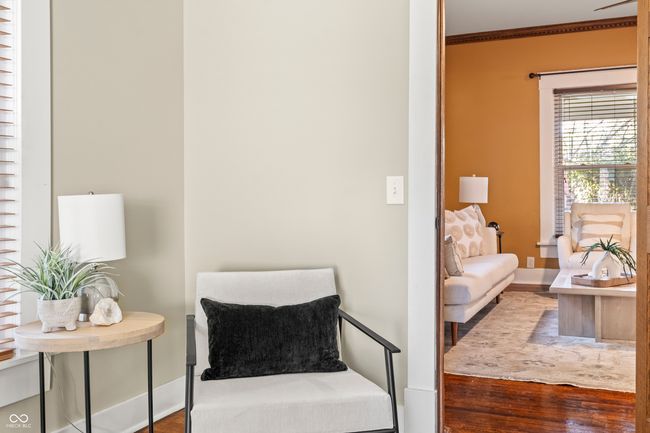 living area with wood finished floors and ornamental molding | Image 27