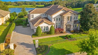 An aerial view of this expansive 0.93-acre estate, offering lakefront living, a beautiful and private backyard on serene Lake Hugh. | Image 2